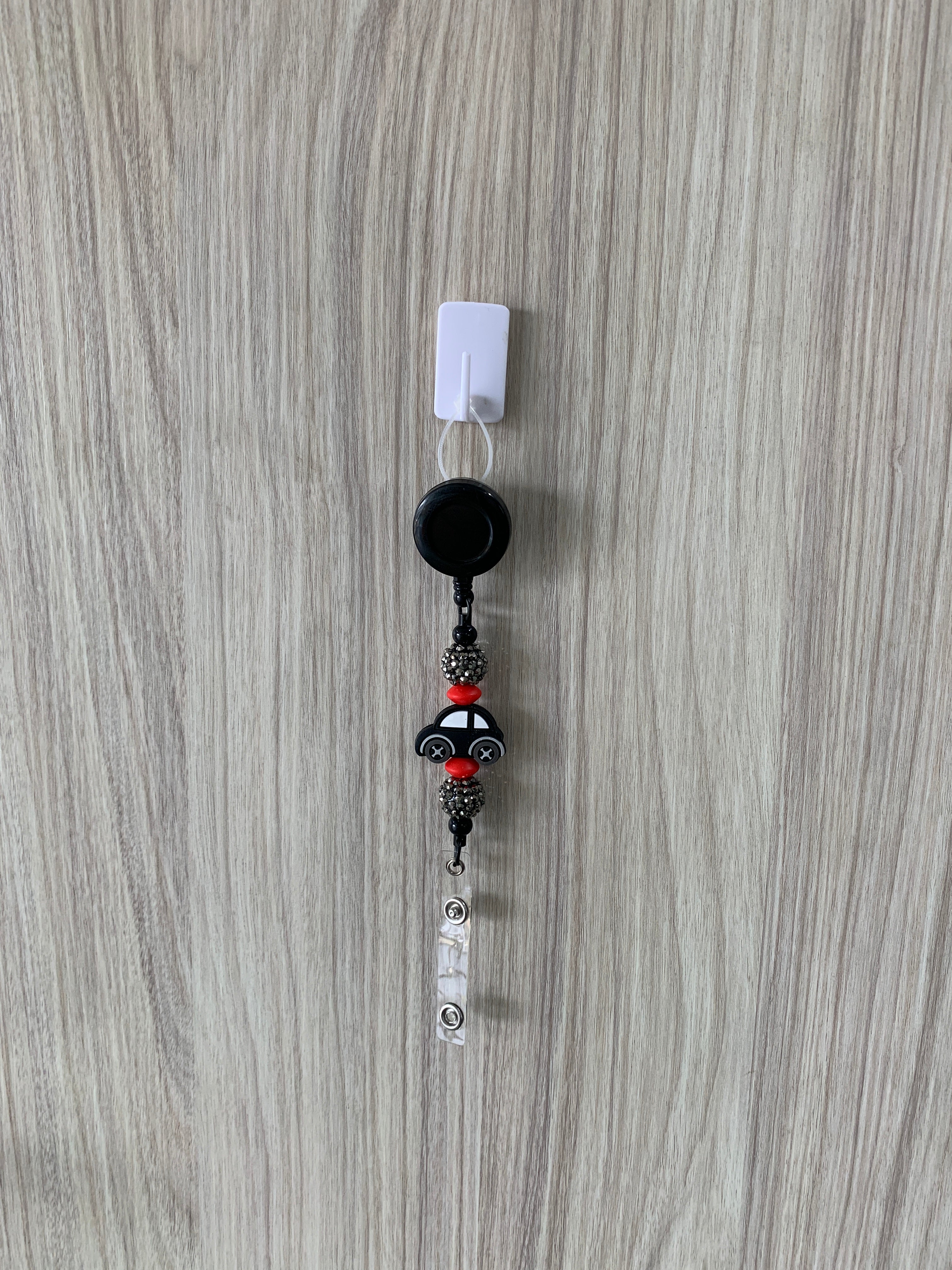 Handmade black car beaded belt clip with red accents